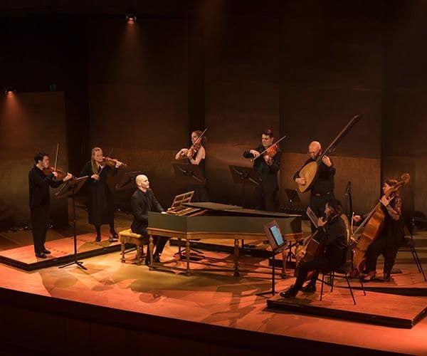 Concertos and Sonatas image depicting two flowers, orange and white, with a black backdrop.