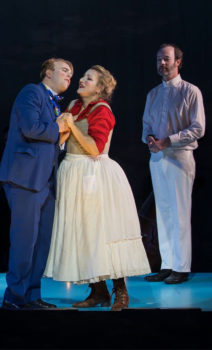 A woman's hand with bright-red nails holds a wooden mop against a blue background.