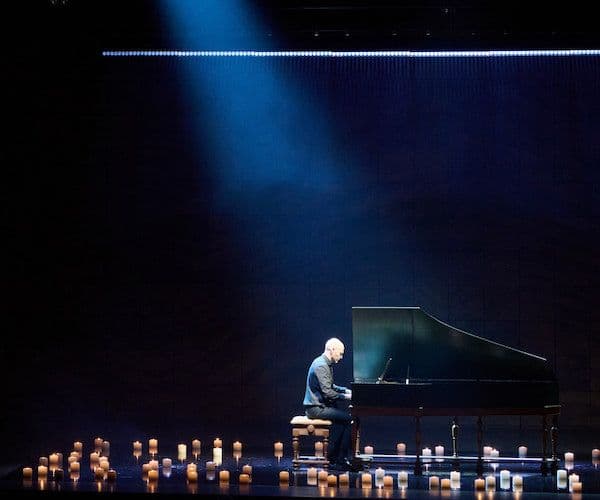 Goldberg variations Erin Helyard plays the harpsichord on stage surrounded by candles, with